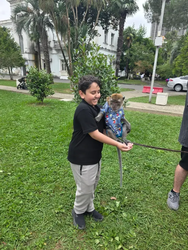 My little brother with a monkey in a park in Batumi